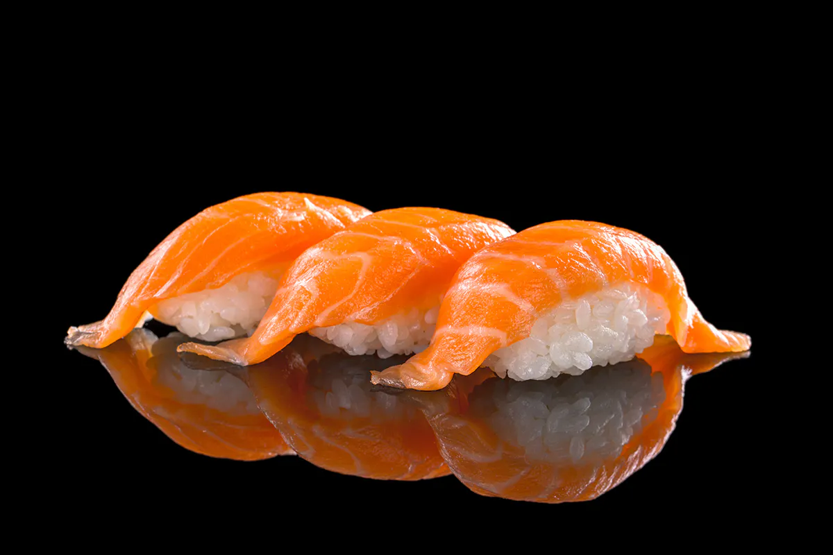 Sushi chef garnishing specialty rolls with microgreens at Takora, a Japanese Restaurant in Houston